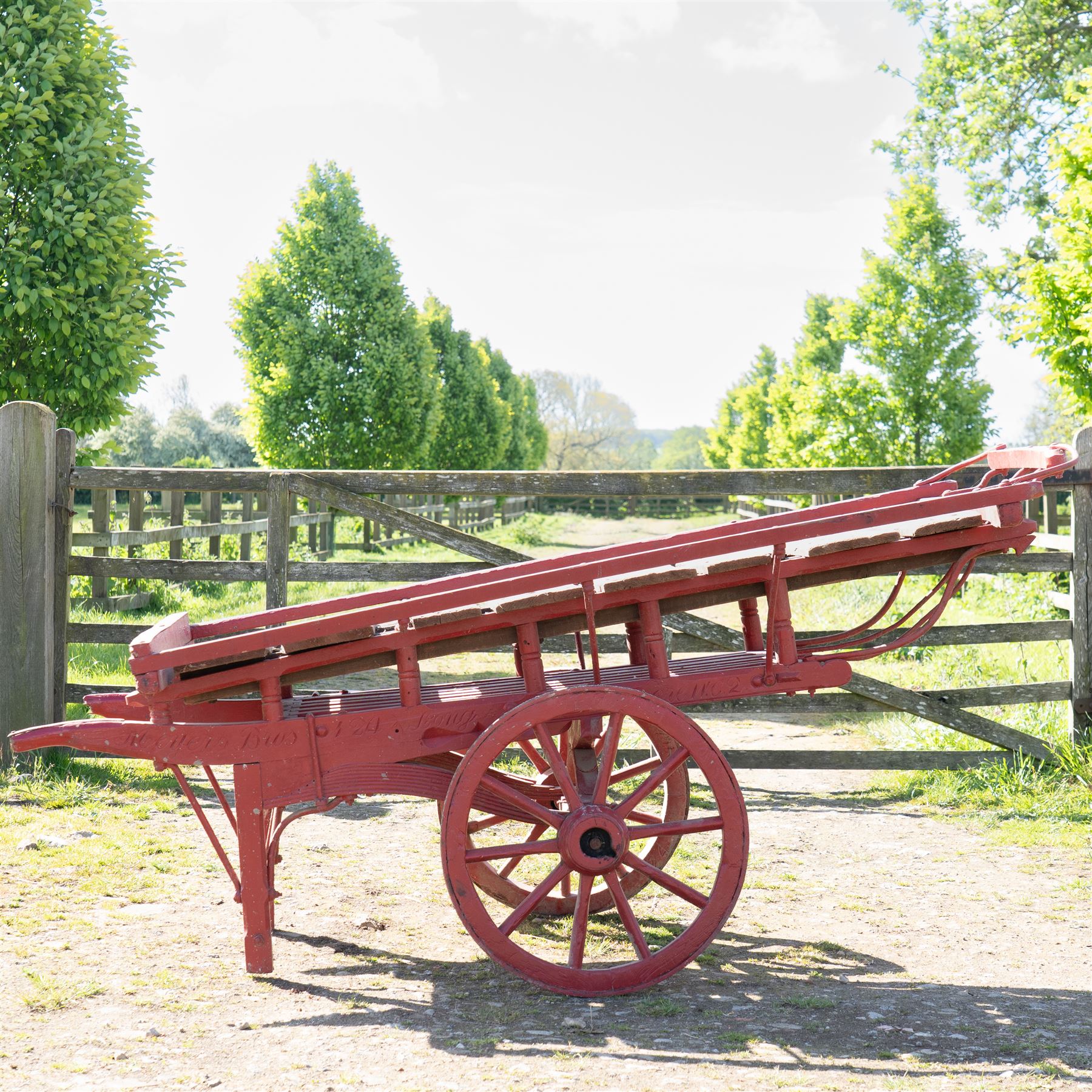 Costermonger’s Cart

A painted costermonger’s cart with red timber frame, slatted deck and wooden spoked wheels. The cart has long hand rails, raised side rails and turned supports, with incised inscriptions to the frame, including “Meyers Bros”. The form is consistent with a hand drawn market cart, used for carrying and displaying produce or goods.

Features:
Red painted timber frame
Slatted wooden deck
Wooden spoked wheels
Long hand rails
Raised side rails
Turned timber supports
Incised inscriptions to the frame
“Meyers Bros” inscription visible
Traditional market cart form

Dimensions:
Length: 240 cm (body approximately 210 cm)
Width: 102 cm
Height: 92 cm

Wheel diameter: 67 cm