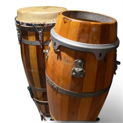 Three conga drums, comprising two Excelsior A. Salvadori Firenze stave-built wooden congas and one similar French example, with skin heads and metal tension mounts, on metal stands with hard carry cases for drums, tallest H79cm, D31cm