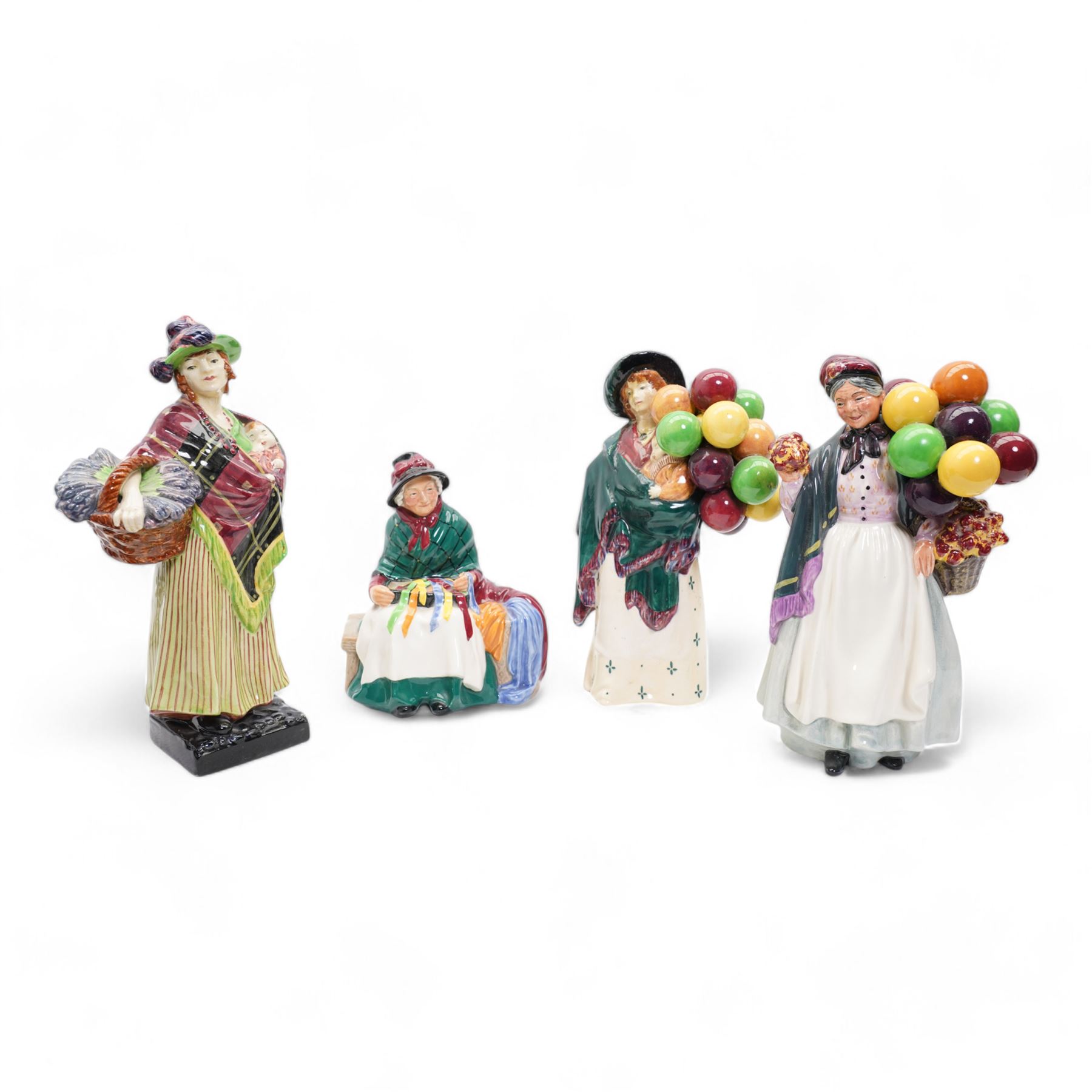 Four Royal Doulton figures comprising 'Sweet Lavender' HN1373, 'The Balloon Seller' HN583, 'Biddy Pennyfarthing' HN1843 and 'Silks and Ribbons' HN2017 (4)