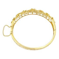 14ct gold diamond flower head hinged bangle, seven graduating flowers, each set with a single round brilliant cut diamond, to a pierced and engraved foliate body, stamped