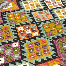Afghan Maimana flatweave kilim runner, central field features large bold nested diamond motifs and stylized geometric lozenge patterns on olive purple, ochre, blue, and green tone ground, border stripe in orange tones with fringe