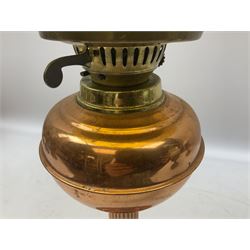 Copper and brass oil lamp with a corinthian column  chimney and yellow glass shade, together with five other similar examples