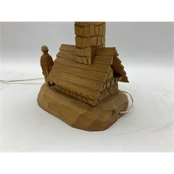 Mid 20th century Paul Caron carved table lamp, modelled as man standing before an oven, the chimney supporting the panelled shade, the base signed P.E. Caron, H42cm