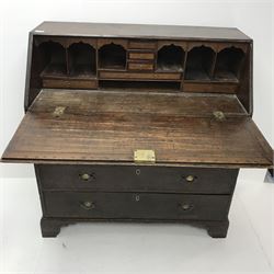 19th century oak bureau, fall front enclosing fitted interior above seven graduating drawers, ogee bracket supports, W104cm, H107cm, D48cm