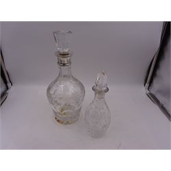 Two modern silver mounted decanters, the first example with etched and cut fruiting vine decoration to glass body, with faceted stopper, hallmarked C J Vander Ltd, Birmingham 1980, the second smaller example, with oval cut decoration and flambe type stopper, hallmarked S J Rose & Son, Birmingham 1985, tallest H28.5cm