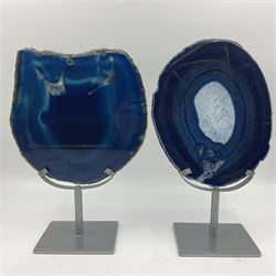 Pair of blue agate slices, polished with rough edges, raised upon silvered metal stands, H26cm