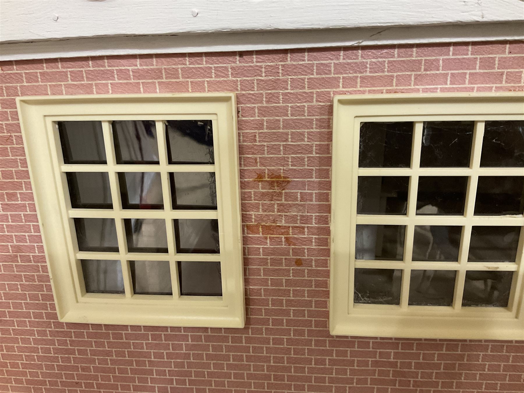 Modern scratch-built Palladian style wooden dolls  house as a 19th century double fronted two-storey property with simulated brick and stone walls under a removable simulated slate hipped roof; the triple hinged front elevation opening to reveal six rooms with central hall, stairs and landing L94cm H56cm D40cm