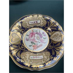 19th century teacup and saucer, possibly Coalport, decorated with panels of flowers on a cobalt blue ground with gilt decoration; together with two other teacup and saucer pairs, one with hand painted landscape decoration 
