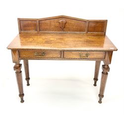 Late Victorian oak side/console table, raised arched back with beaded detail and applied shield shaped mount, rectangular chamfered top over two drawers, tapering octagonal supports