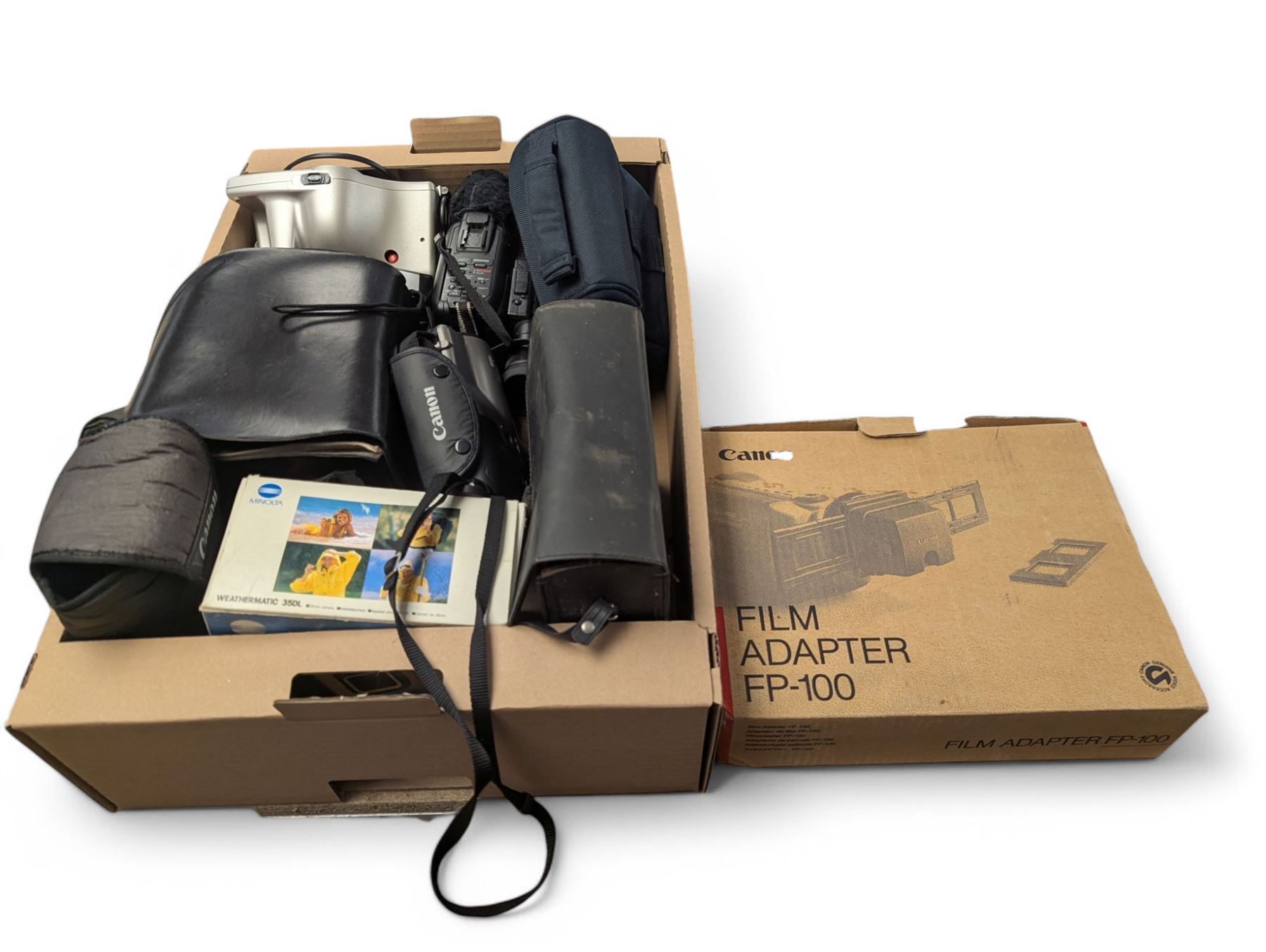 Collection of cameras, including Polaroid Joycam, Hanshing Cam digital camera, Kodak Pocket Instamatic 400, Mirage 20 cine cam, Polaroid Colorpak 80, Canon E230 camcorder, Minolta Weathermatic 35DL and a Canon Epoca camcorder