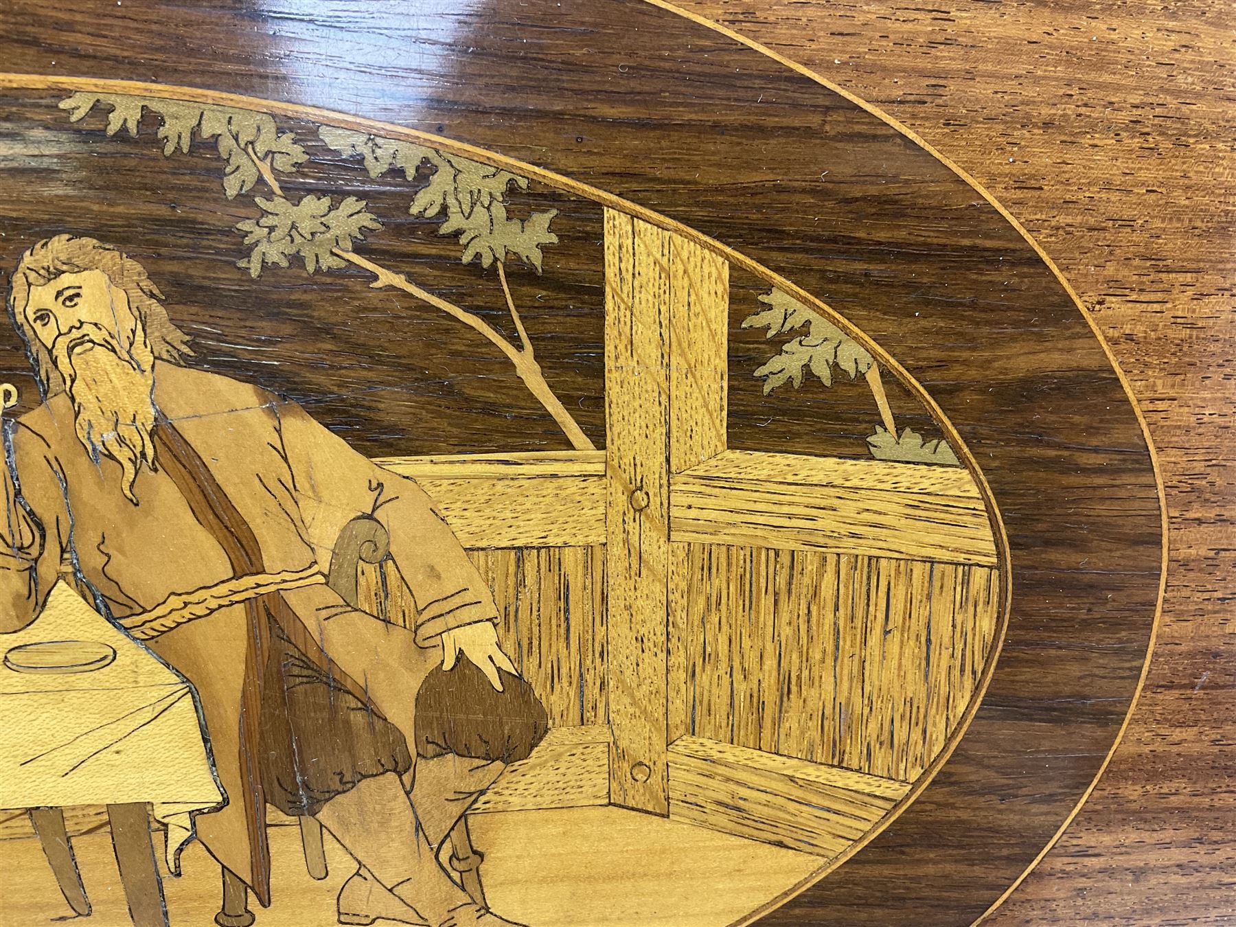 Late 19th/early 20th century mahogany and marquetry inlaid tray, of oval form with twin scrolled handles and moulded border, the central panel inlaid with figures seated at a table drinking tea, L99cm