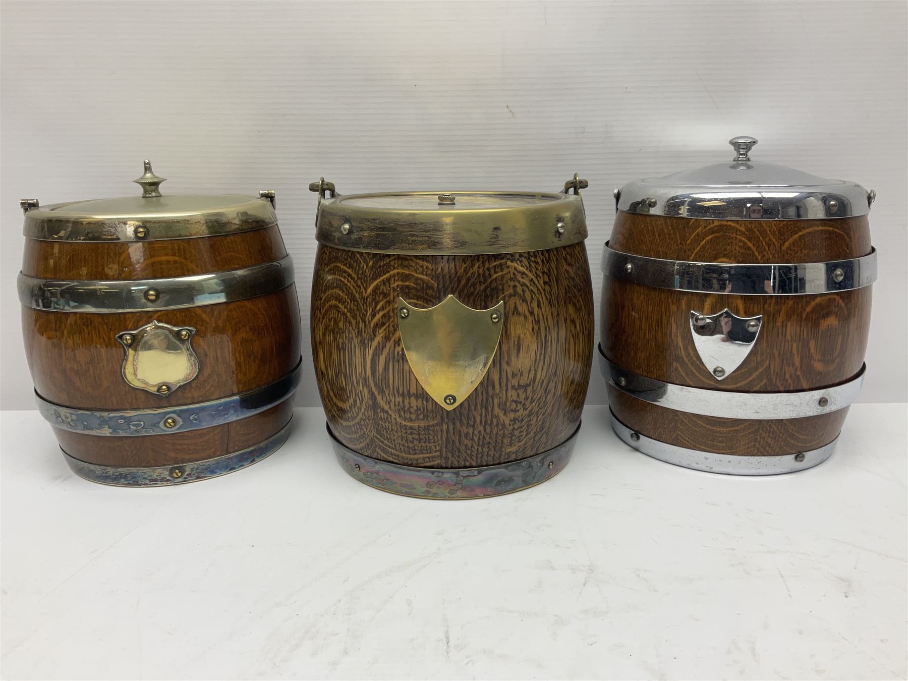 Five early 20th century biscuit barrels with silver-plated mounts