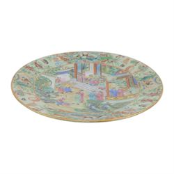19th century Chinese Canton export celadon ground famille rose charger, of circular dished form decorated with a central panel of figures in a court setting, within a border of blossoms, birds and butterflies, D34.5cm