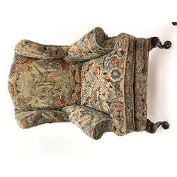 Matched pair early 20th century Queen Anne style wingback armchairs, walnut framed, sprung seats with seat cushions upholstered in needle work cover, shell carved cabriole front feet