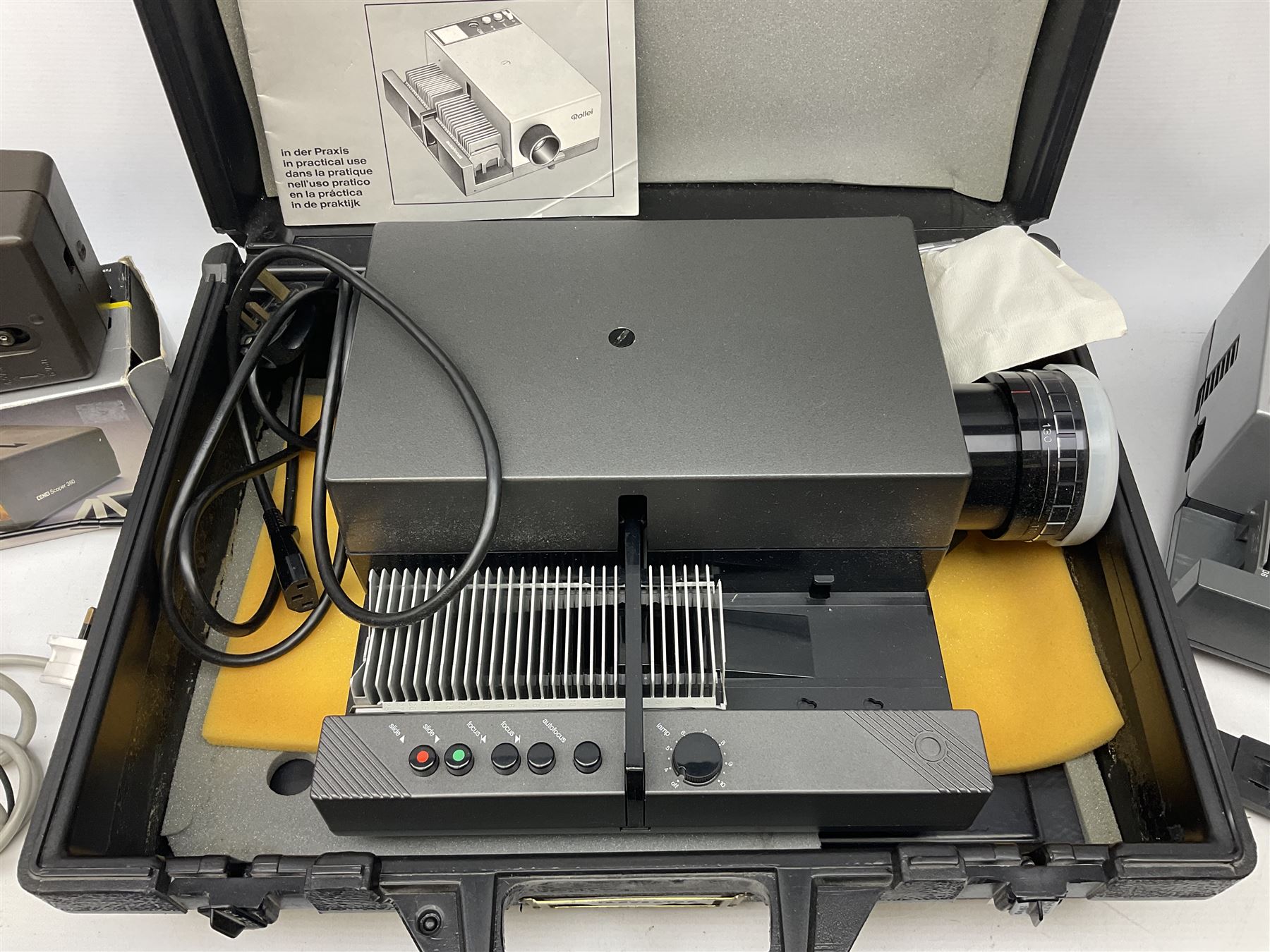Cased Rollei projector together with a palar projector screen, autofocus slide projector and cenei scoper 360 