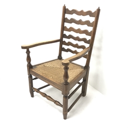 Early 20th century oak fireside armchair, shaped ladder back, reeded drop in seat, turned supports joined by stretchers, W59cm