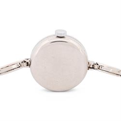 Audemars Piguet & Co Art Deco ladies platinum, diamond set manual wind wristwatch, movement No. 19931, cream / silvered dial with Arabic hour markers, the bezel milgrain set with round cut diamonds, to a platinum expanding bracelet