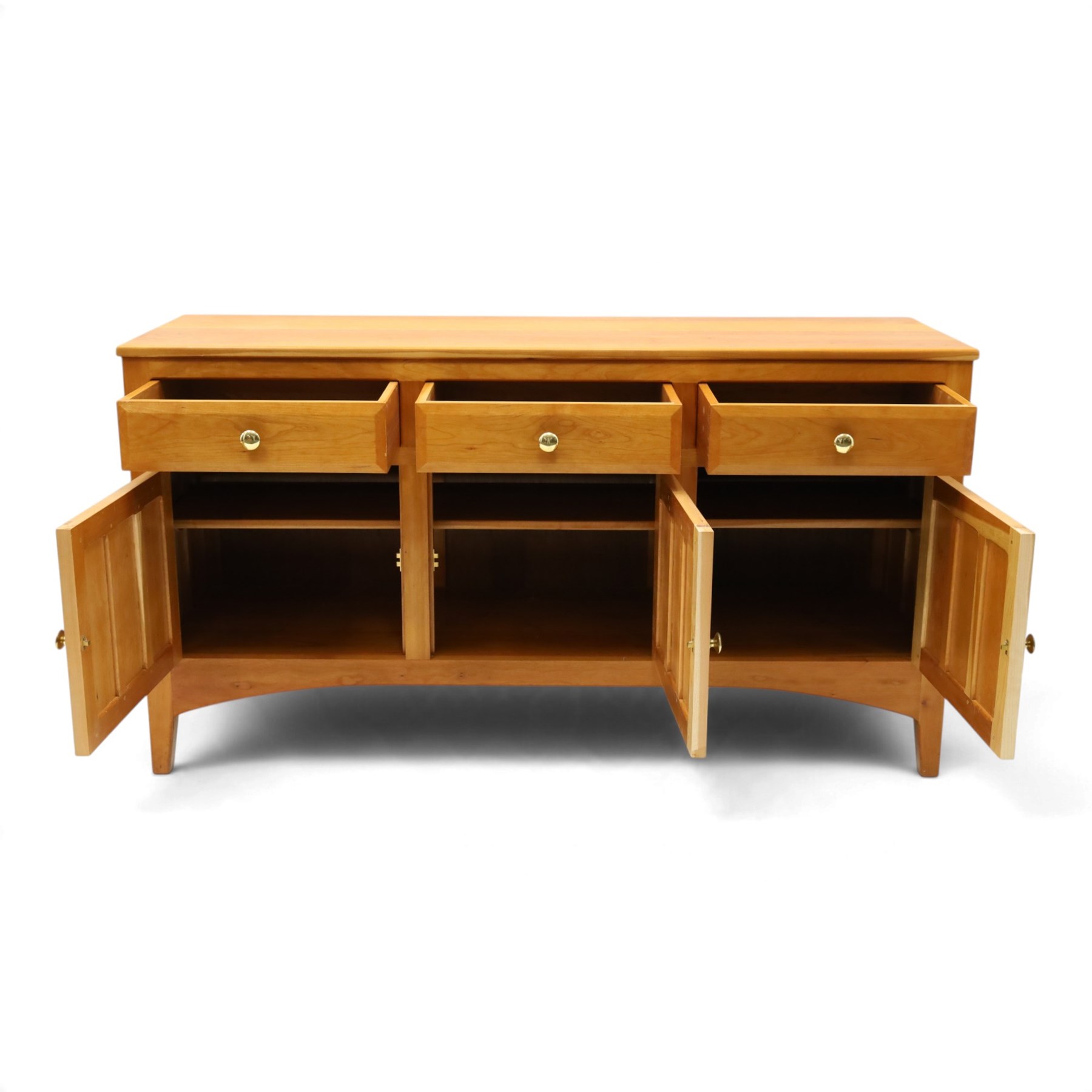 Traditional cherrywood sideboard, rectangular top above three fielded panelled drawers, three cupboard doors with triple panelled doors, brass knobs and hinges, tapered supports