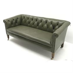Low back settee upholstered in buttoned green leather, square tapering supports with brass cups and castors, W155cm
