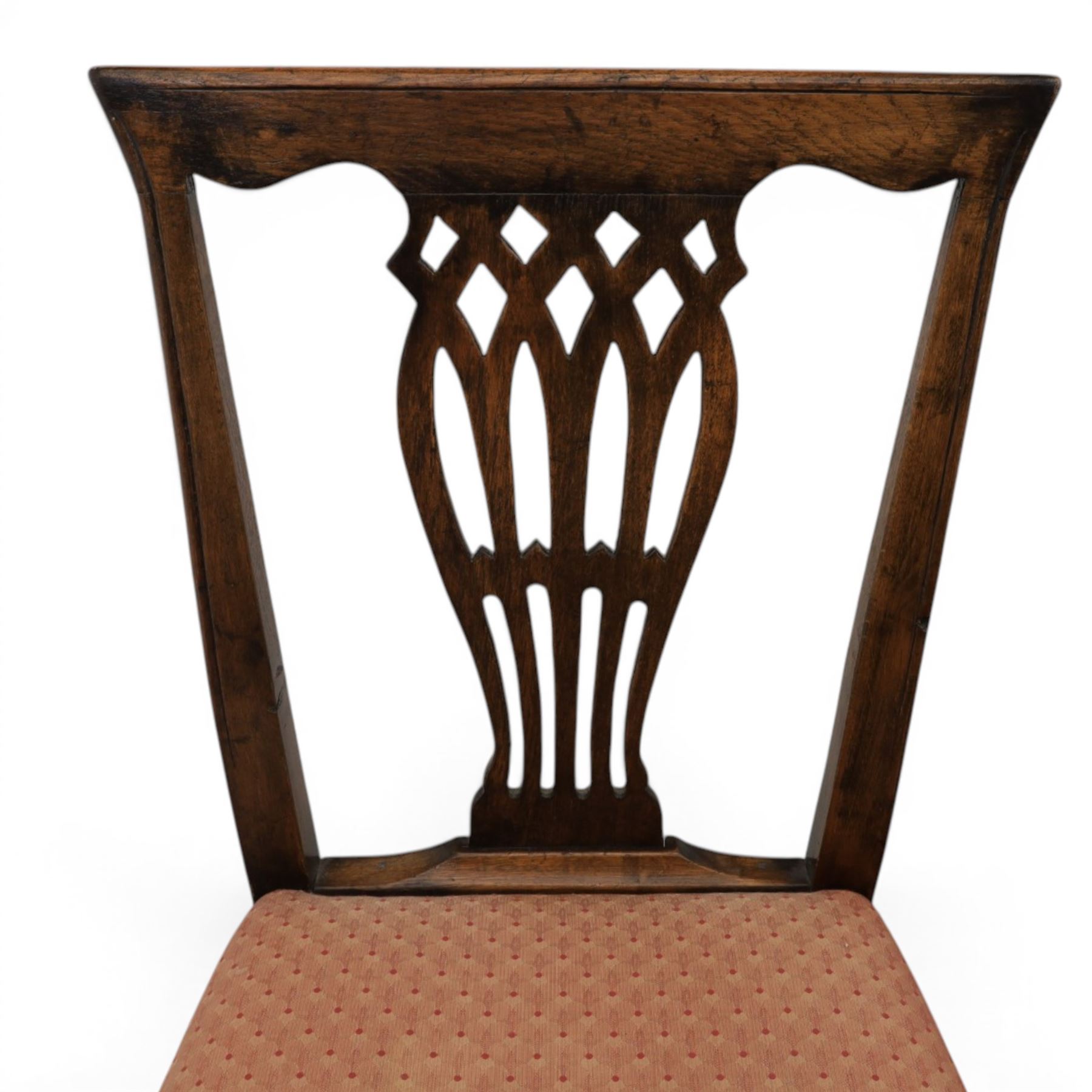 Set of eight George III dining chairs with padded seats, pierced vasiform splat, upholstered seat with brass trim, on square supports with H-stretcher