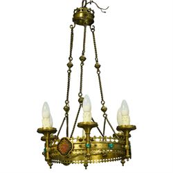 Gothic Revival brass six-light ecclesiastical chandelier, circular frame with pierced trefoil cresting and apron, applied with polychrome Sacred Heart medallions, six candle-form electric sconces, suspended on twisted brass rods and chains from a coronet-form ceiling boss