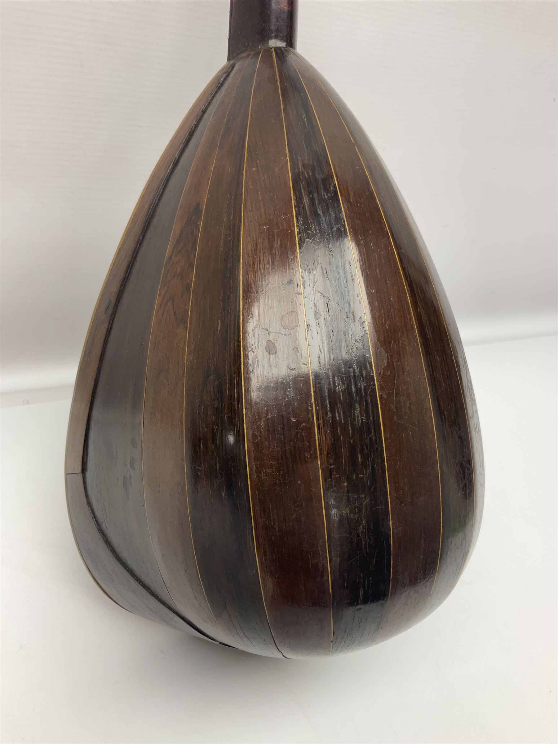 Late 19th century Italian lute back mandolin with segmented bowl back, bears label Gennaro Maglioni Napoli L61cm; in ebonised wooden case; together with another similar damaged Italian lute back mandolin for restoration or spares (2)