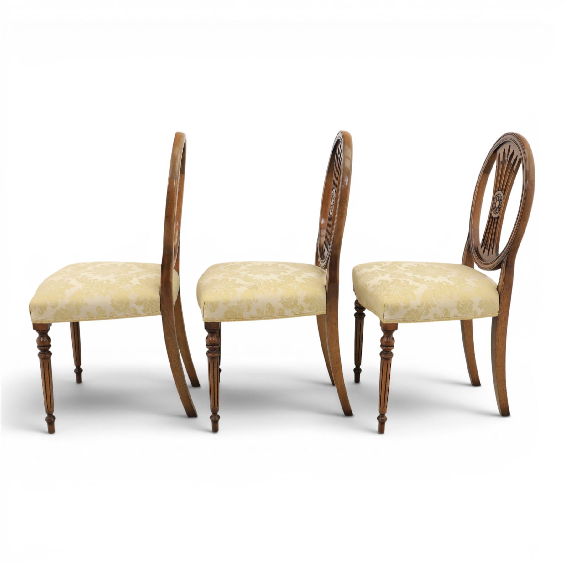 Bevan Funnell Reprodux - Regency design set of ten mahogany dining chairs, oval backs with central splat with rose motif, serpentine seat upholstered in damask fabric, raised on turned supports