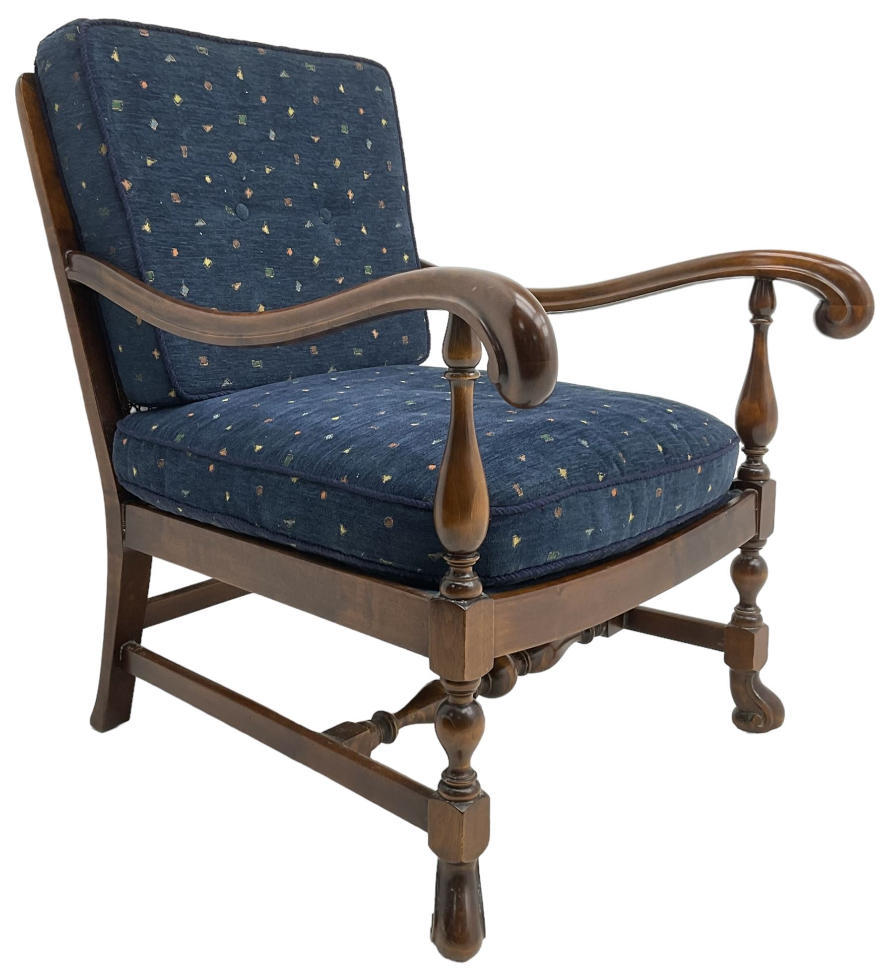 Early 20th century stained beech framed armchair, cane panel back over scrolled arm terminals, raised on turned supports united by turned H-stretcher, with patterned blue upholstered loose back and seat cushions