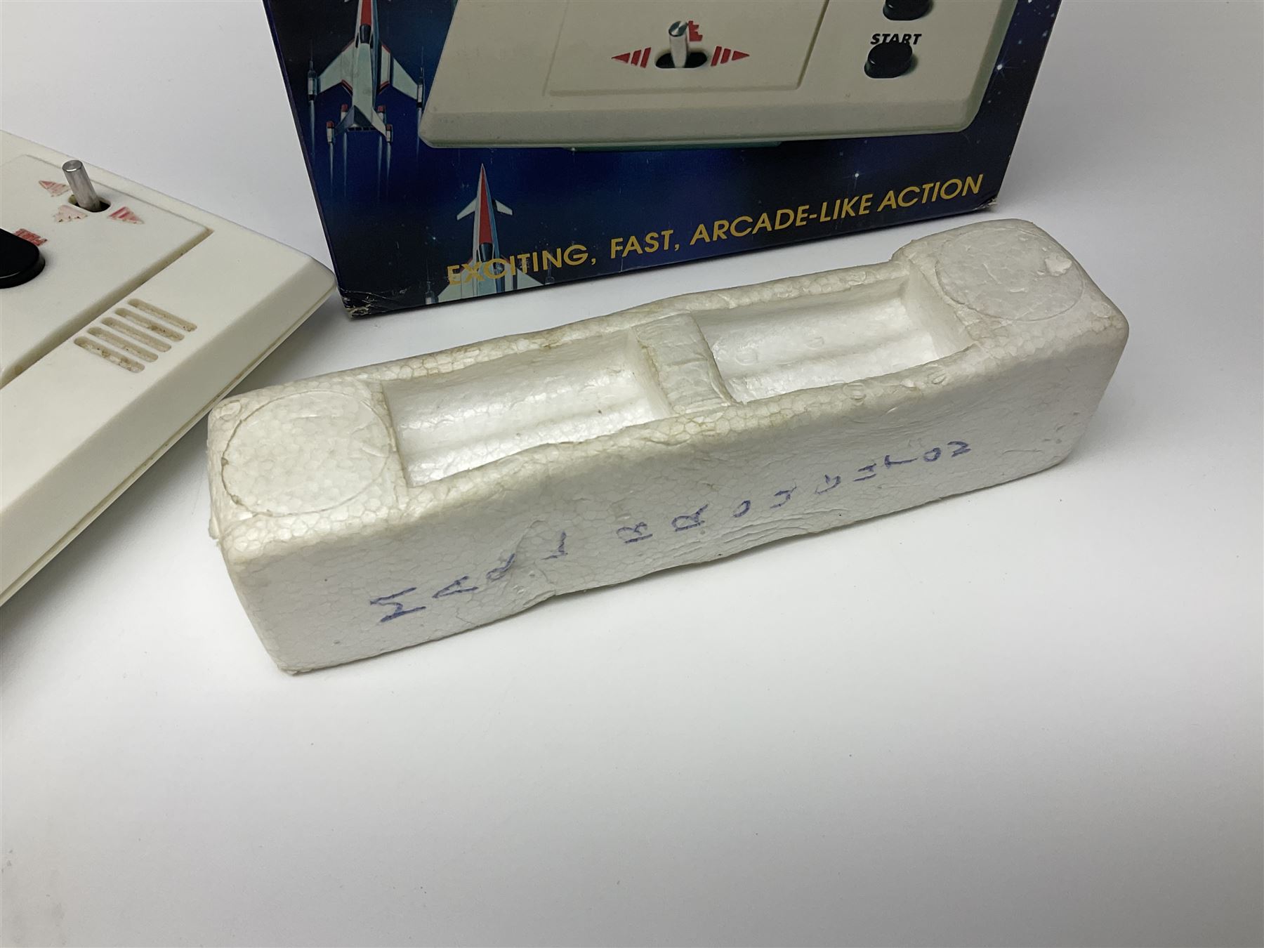 Three late 70s/early 80s handheld electronic games; Bandai Electronics Arcade ‘Gunfighter’ (1980), Grandstand ‘Invader From Space’ (1980), Palitoy ‘Merlin The Electronic Game Machine’ (1979) with game sheet and instruction booklet, all with original boxes (3) 