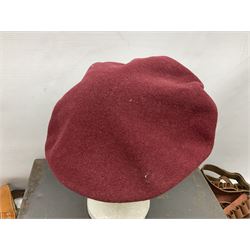 Assorted militaria including ten leather or canvas cartridge and other belts, maroon beret with 17th Lancers cap badge, modern bullet mould, leather and brass shot flask, two knives, shell cases, boomerang etc; in tin deed box