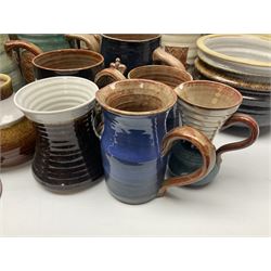 Wold studio pottery tankards, in various colours and relief decoration together with other studio items including vases, jugs and pots 