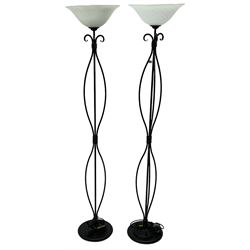 Pair of black finish wrought metal standard lamps with glass shades 
