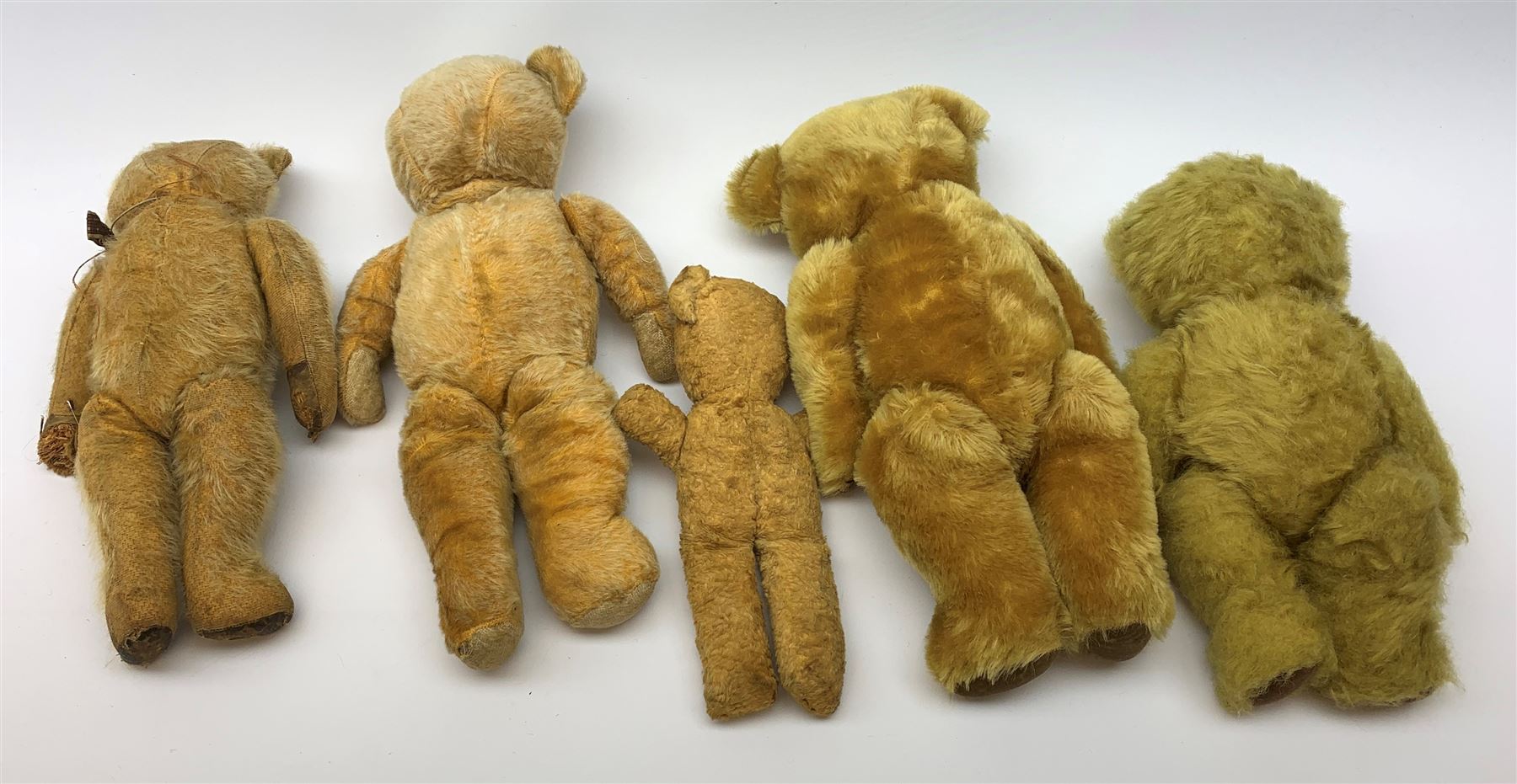Four English teddy bears 1930s-50s including Chad Valley wood wool filled with swivel jointed head, glass type eyes and vertically stitched nose and mouth and jointed limbs H15