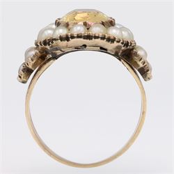 Georgian gold yellow topaz (possibly imperial) and split pearl cluster ring, collect set with a single oval cut foiled back topaz, surrounded by fifteen pearls and pearl set scroll engraved trefoil shoulders