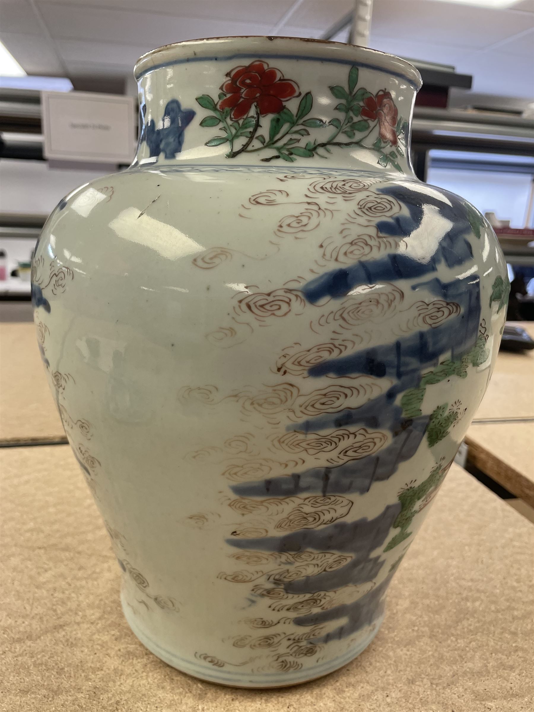 17th century Transitional period Chinese Wucai vase and cover, of baluster form, the body painted with ladies upon a terrace, and figures upon horseback and attendants within a fenced garden, the domed cover with knop finial painted with boys at play, H37cm
