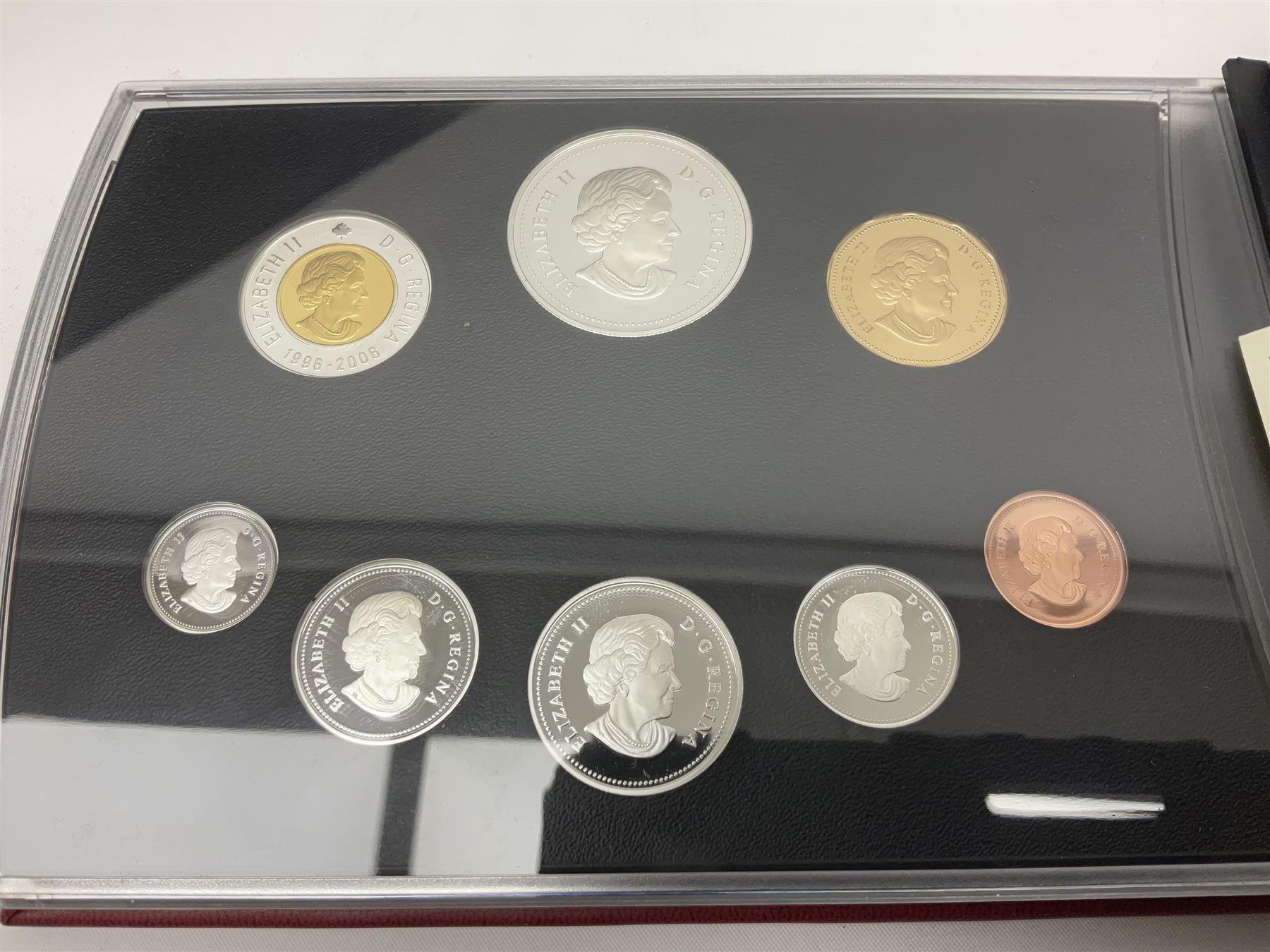 Queen Elizabeth II The Royal Canadian Mint 2006 silver proof dollar and two 2006 proof sets of Canadian coinage, all cased with certificates 