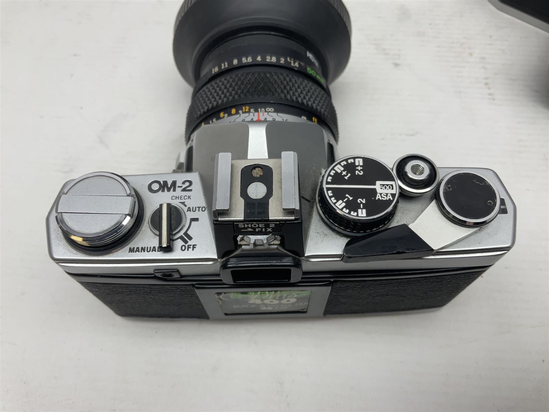 Four Olympus camera bodies, including Olympus OM10, serial no 20744269, with 'Olympus OM-System Zuiko Auto-S 50mm 1:1.8' lens serial no 3633644, Olympus OM-2 camera body serial no 460280 with 'Olympus OM-System G.Zuiko Auto-s 1:1.4 f=50mm' lens, serial no 729750, etc 