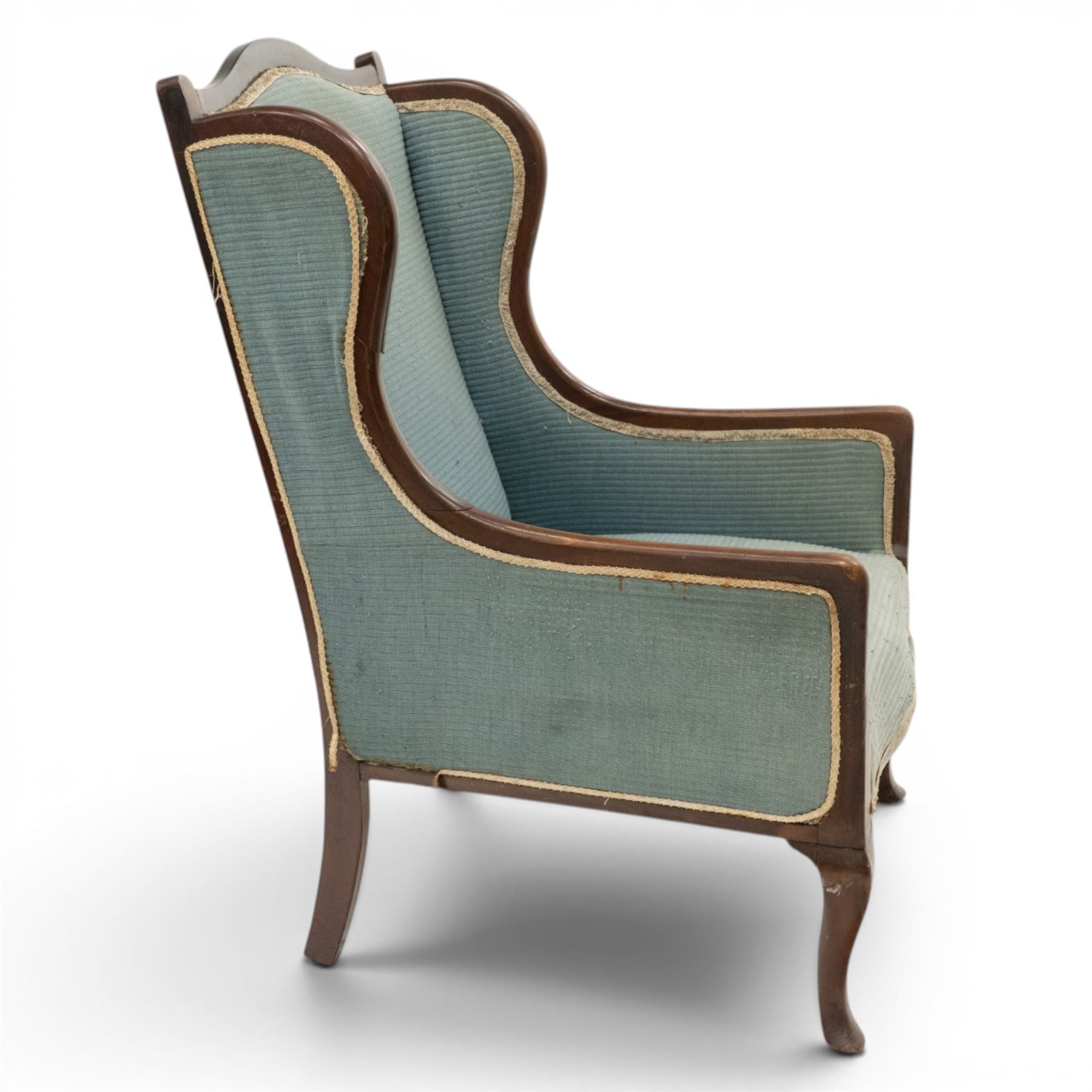 Edwardian armchair of squared form upholstered in blue fabric, serpentine seat front, shaped frame raised on cabriole supports