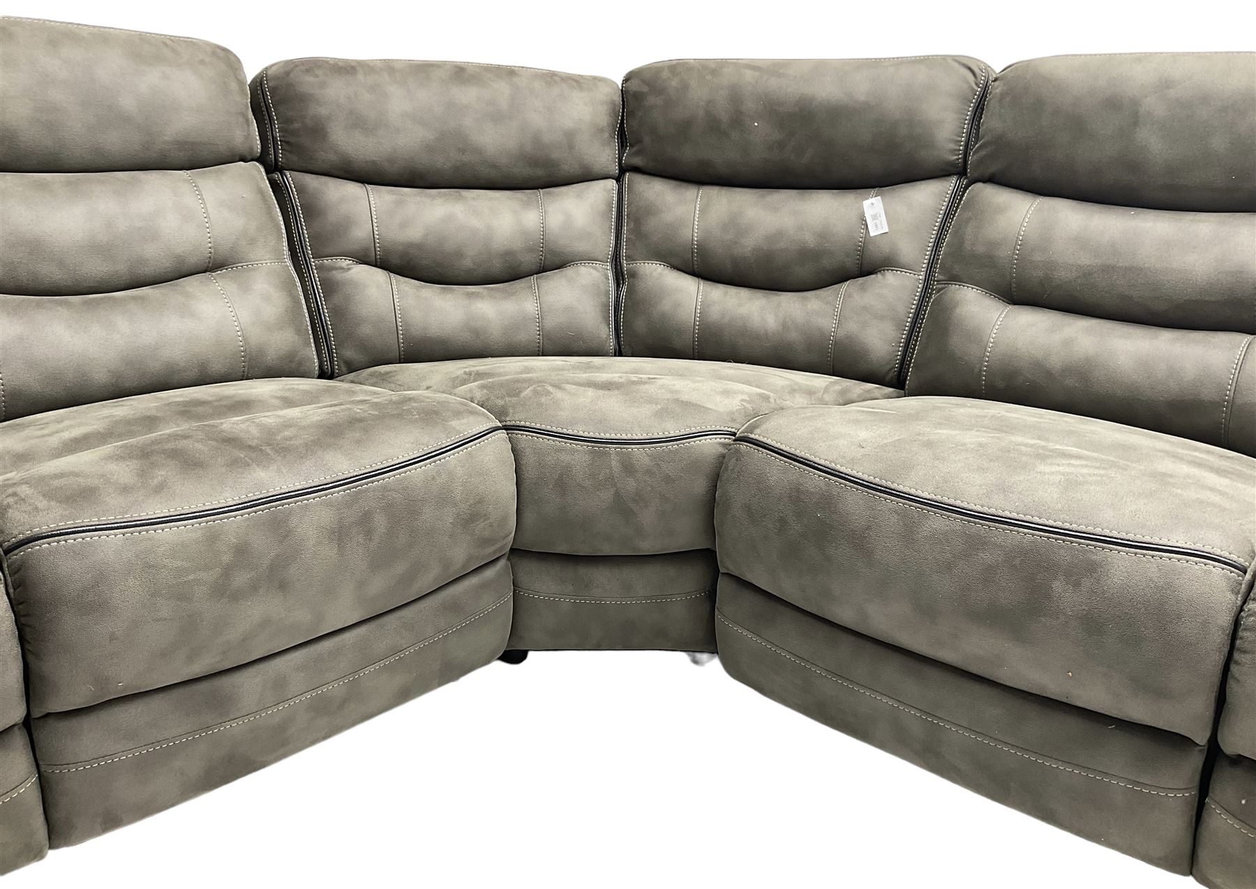 Large contemporary reclining corner sofa, upholstered in gunmetal grey faux suede fabric with black piping