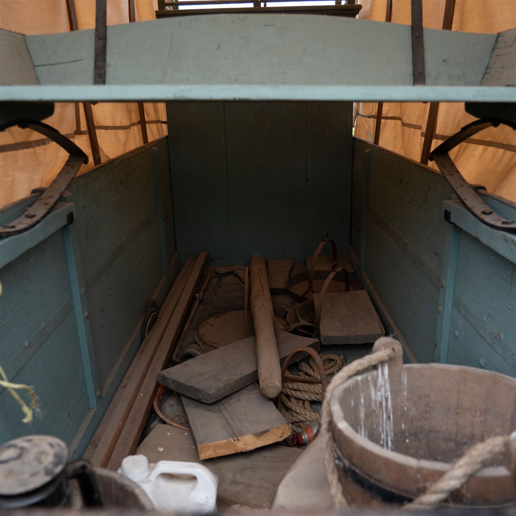 Western Covered Chuck Wagon

A large four wheeled covered wagon of timber construction, painted pale green with red painted wooden spoked wheels and a cream canvas tilt over an arched frame. The wagon has a traditional box body with covered rear compartment, front driving position, underbody turntable steering and iron fittings throughout. Fitted with external equipment details including a side mounted barrel, lidded storage chest, rope tie downs, horseshoe fittings and rear storage box.

Features

• Pale green painted timber body
• Cream canvas tilt over arched frame
• Covered rear compartment
• Front driving position
• Side mounted barrel
• External lidded storage chest
• Rear storage box
• Wooden spoked wheels
• Iron tyres
• Underbody turntable steering
• Rope tie downs
• Horseshoe fittings
• Iron hardware and brackets
• Brass restoration plaque to rear

Dimensions:
Overall length: 335 cm
Width: 170 cm
Height: 275 cm

Wheel Diameters:
Front wheels: 92 cm
Rear wheels: 112 cm

Seating:
Driver: 1
Passenger: Rear covered compartment