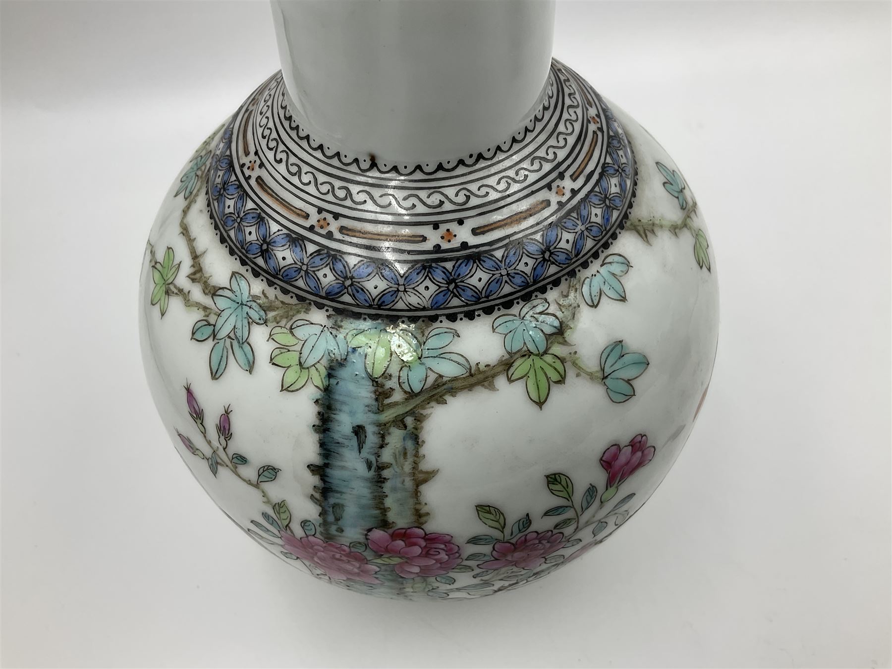 Pair of Chinese Republic porcelain vases, each painted in Famille Rose enamels with pairs of pigeons amidst peony, rock, flowering plants and leafy branches, possibly Qianlong seal beneath, H22cm 