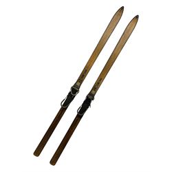 Pair of 1930s wooden skis, with painted metal runners beneath stamped Attenhofer, with retailers label for Ernst Gertsch Central Sports, L206cm