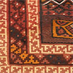 North west Persian Yamut Kilim, madder field with all-over lozenge lattice and serrated edges, with stepped end-panels and bold geometric borders in red, ivory and black