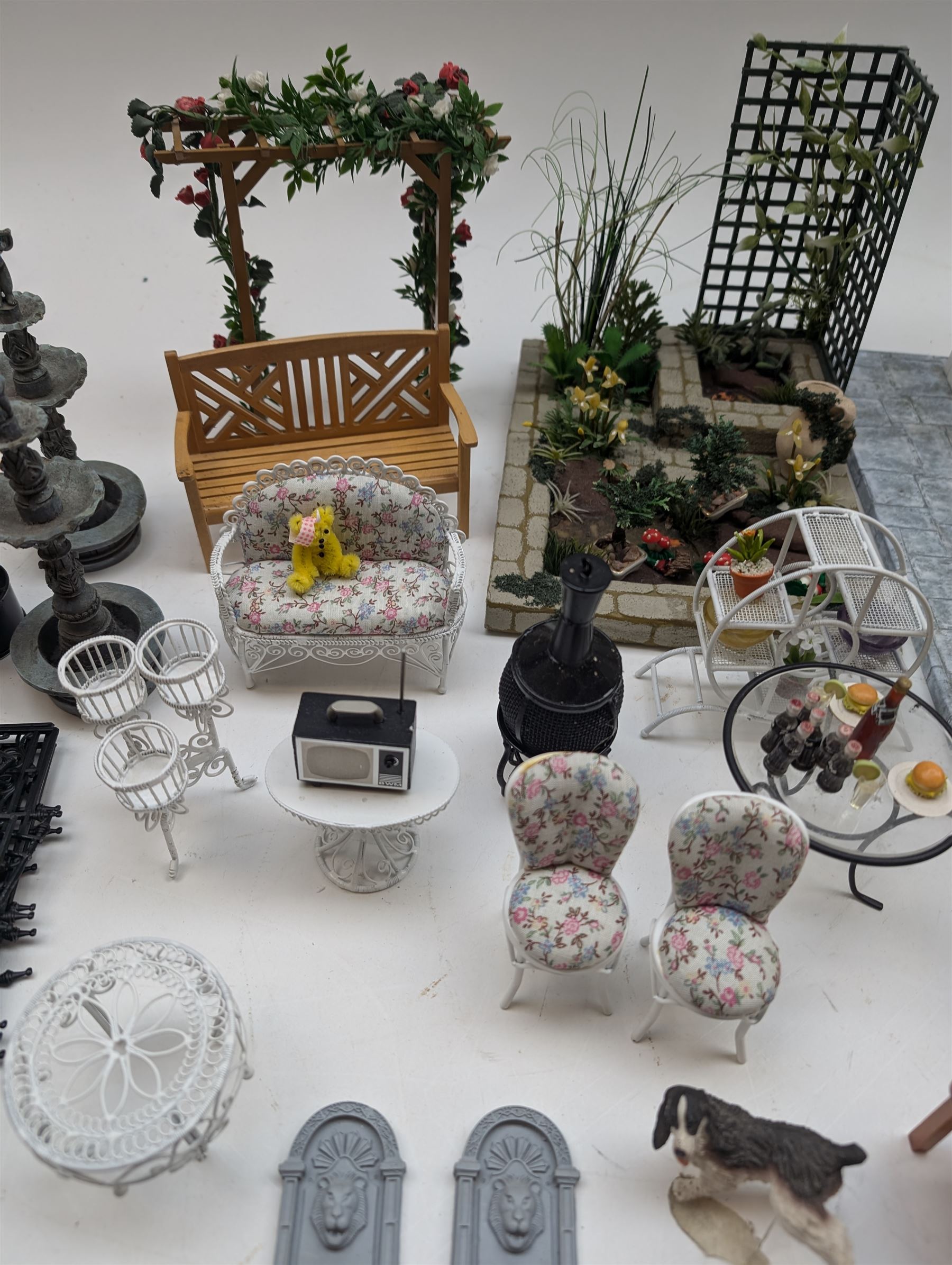1:12 scale dolls house conservatory and garden accessories, including white wooden glazed conservatory on a stone effect base, black and white metal garden seating, barbecue, plant shelves, parasol, barbeque accessories, large planters, rabbit hutch, animals, chimenea, etc