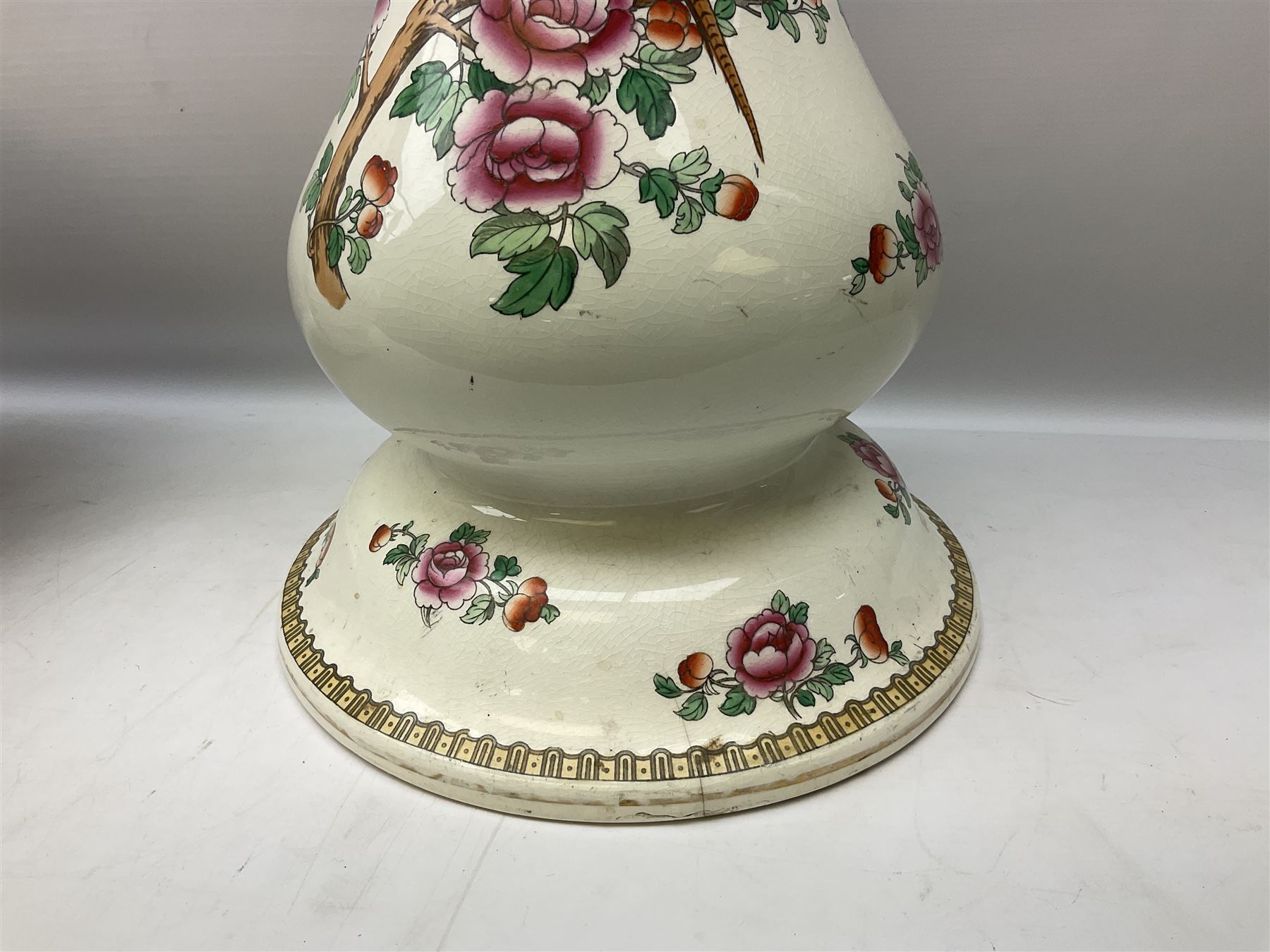 Large ceramic Jardiniere on stand, decorated with an oriental pheasant perched upon branches blossoming with peonies and foliage on white ground, overall H99cm