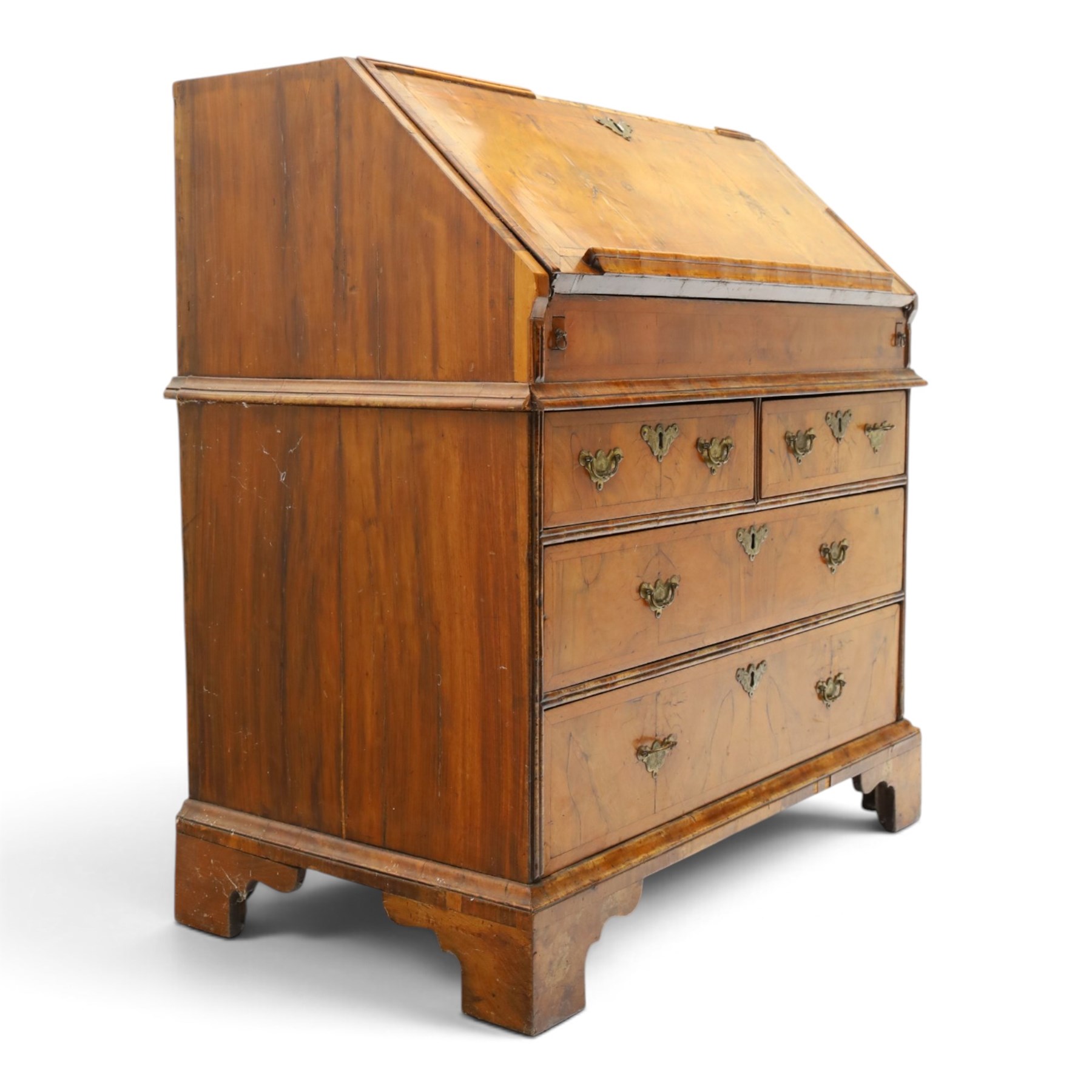 18th century figured walnut bureau, the sloped fall-front enclosing fitted interior with sliding base, pigeon-holes and correspondence drawers with shaped facias, over two short and two long feather-banded drawers with pressed brass handle plates, on bracket feet