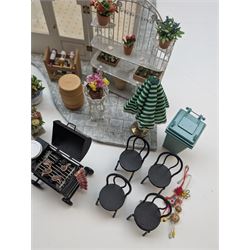 1:12 scale dolls house conservatory and garden accessories, including white wooden glazed conservatory on a stone effect base, black and white metal garden seating, barbecue, plant shelves, parasol, barbeque accessories, large planters, rabbit hutch, animals, chimenea, etc