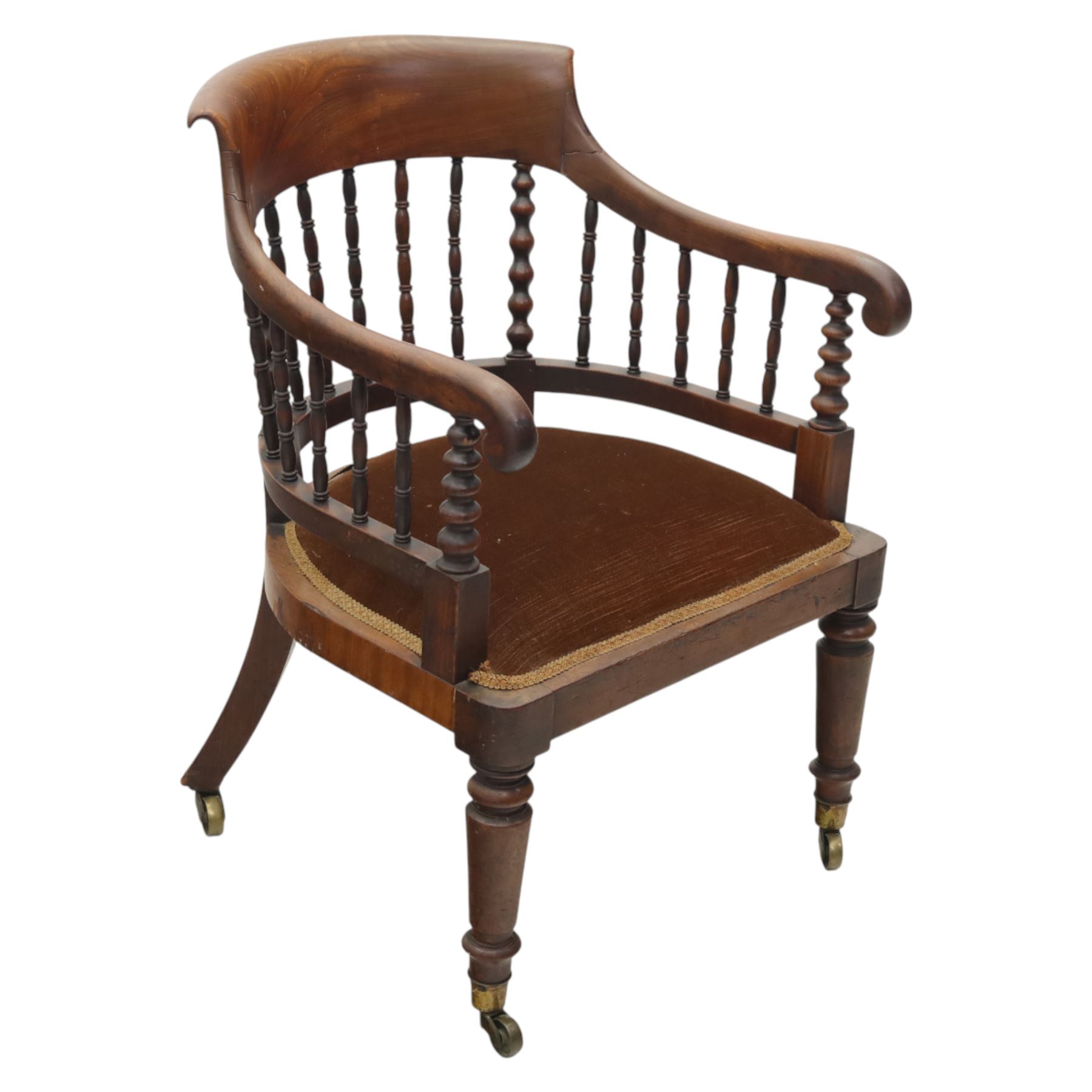 Late 19th-century captain's chair,  with spindle and bobbin turned shaped back, with brown velvet upholstered seat, raised on turned legs with brass castors, old damage and repairs 