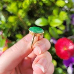 Early - mid 20th century gold jade ring, bezel set with a single oval cabochon jade of approx 4.10 carat, stamped 18ct