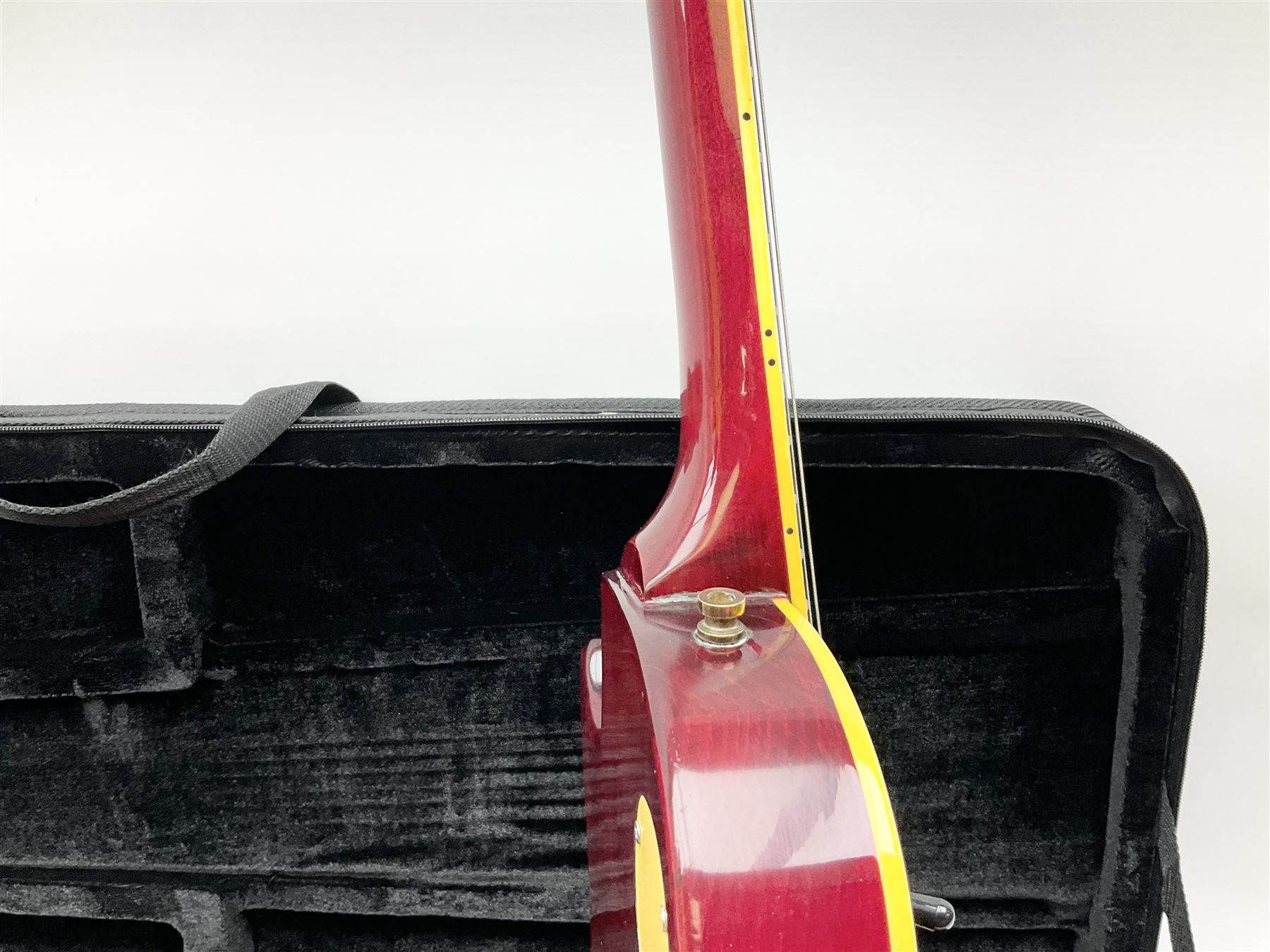 1980s Les Paul Epiphone limited edition cut-away electric guitar by Gibson, the burgundy coloured body with two pick-ups, volume and tone knobs and scratch plate, original tuning pegs, serial no.U6030215, 101cm overall; in modern Kinsman fitted carrying case